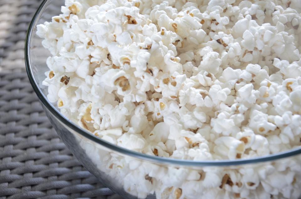 Glass bowl full of fresh popcorn